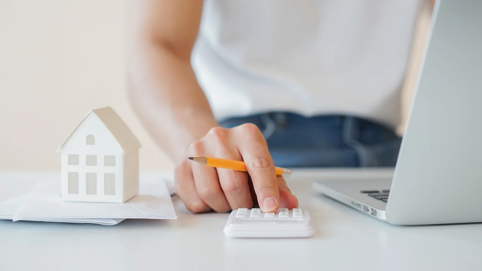 man with a calculator and laptop